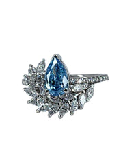 Close-up view of a blue lab grown pear cut diamond ring with a 1-carat centerpiece and white marquise cut cluster, emphasizing the intricate details and sparkling facets of the 1.85 TCW design.
