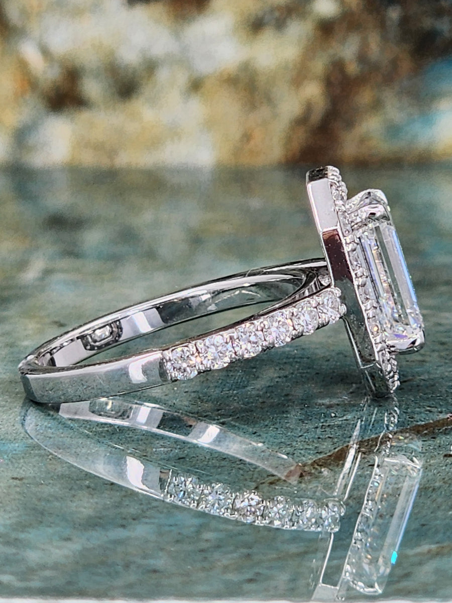Side angle of a lab grown emerald cut diamond ring with intricate prong setting and diamond-accented band, crafted for elegance and depth.

